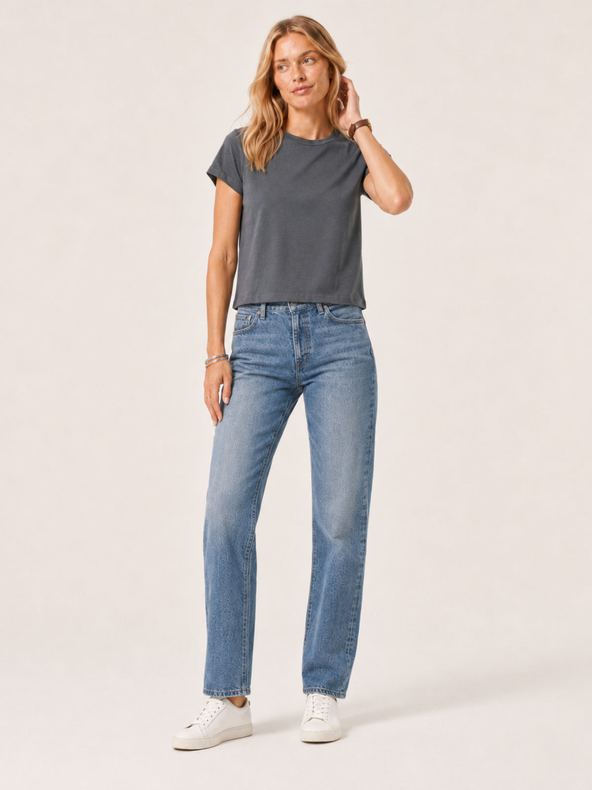 woman modeling a dark gray short-sleeve crewneck t-shirt