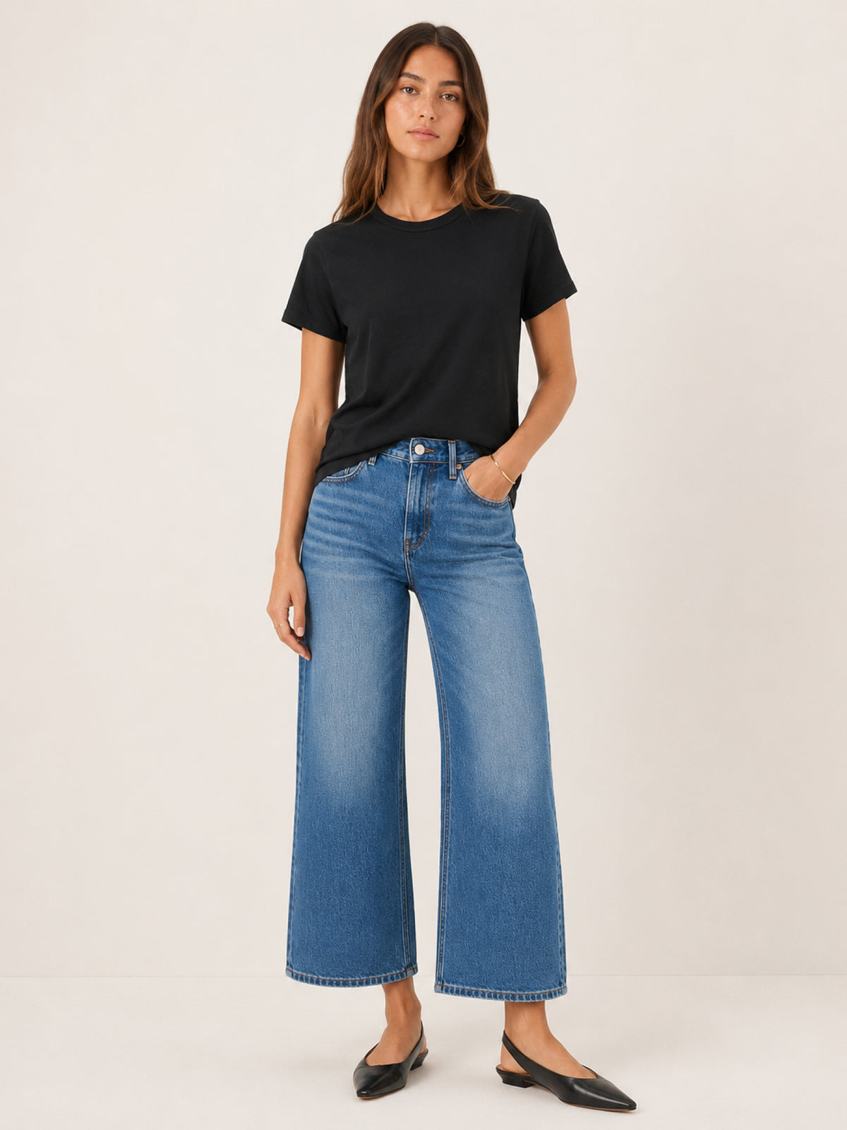 A woman modeling a black short-sleeve crewneck t-shirt