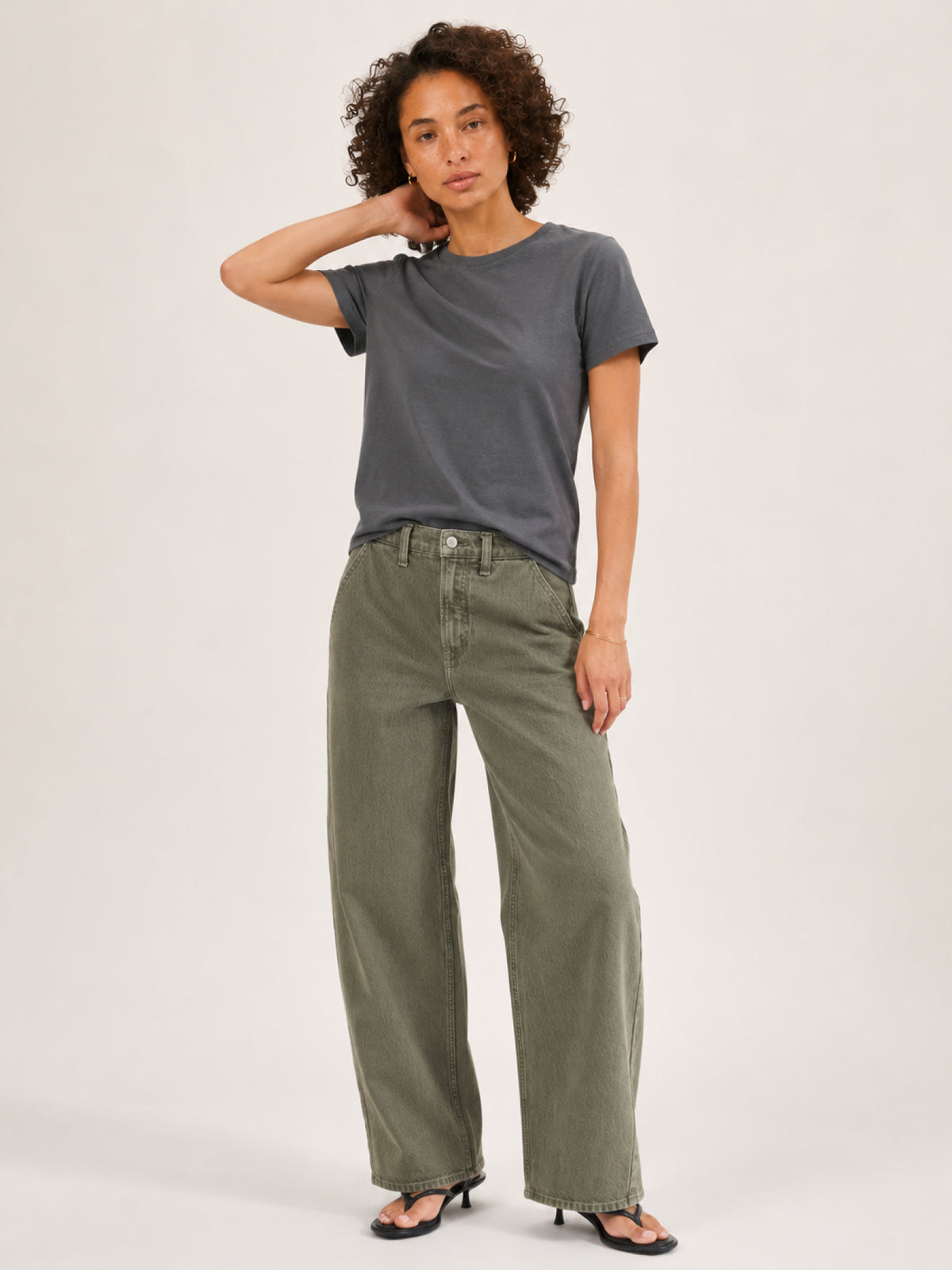 A woman modeling a dark gray short-sleeve t-shirt