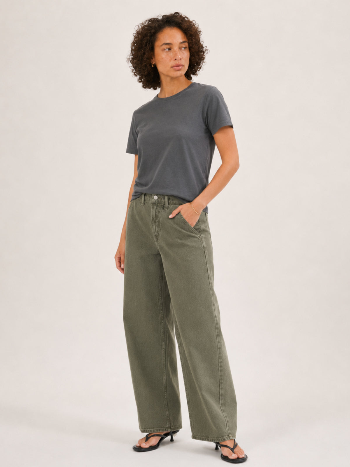 A woman modeling a dark gray short-sleeve t-shirt