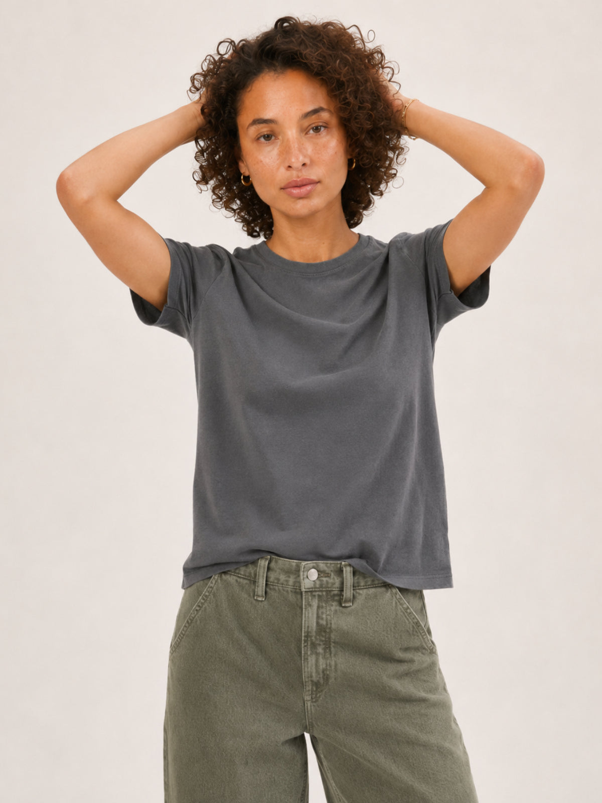 A woman modeling a dark gray short-sleeve t-shirt