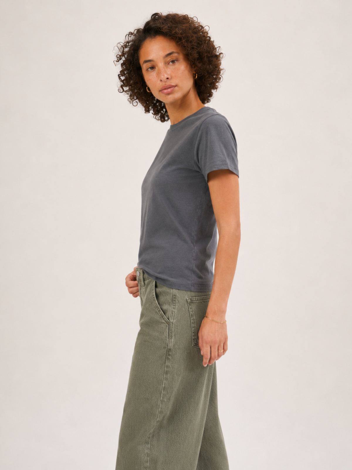 A woman modeling a dark gray short-sleeve t-shirt