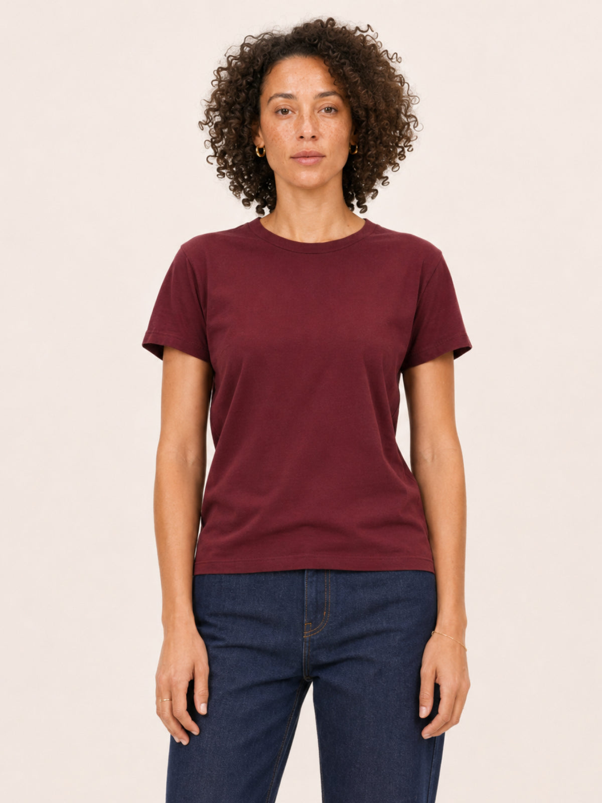 wearing a short-sleeve crewneck t-shirt in maroon