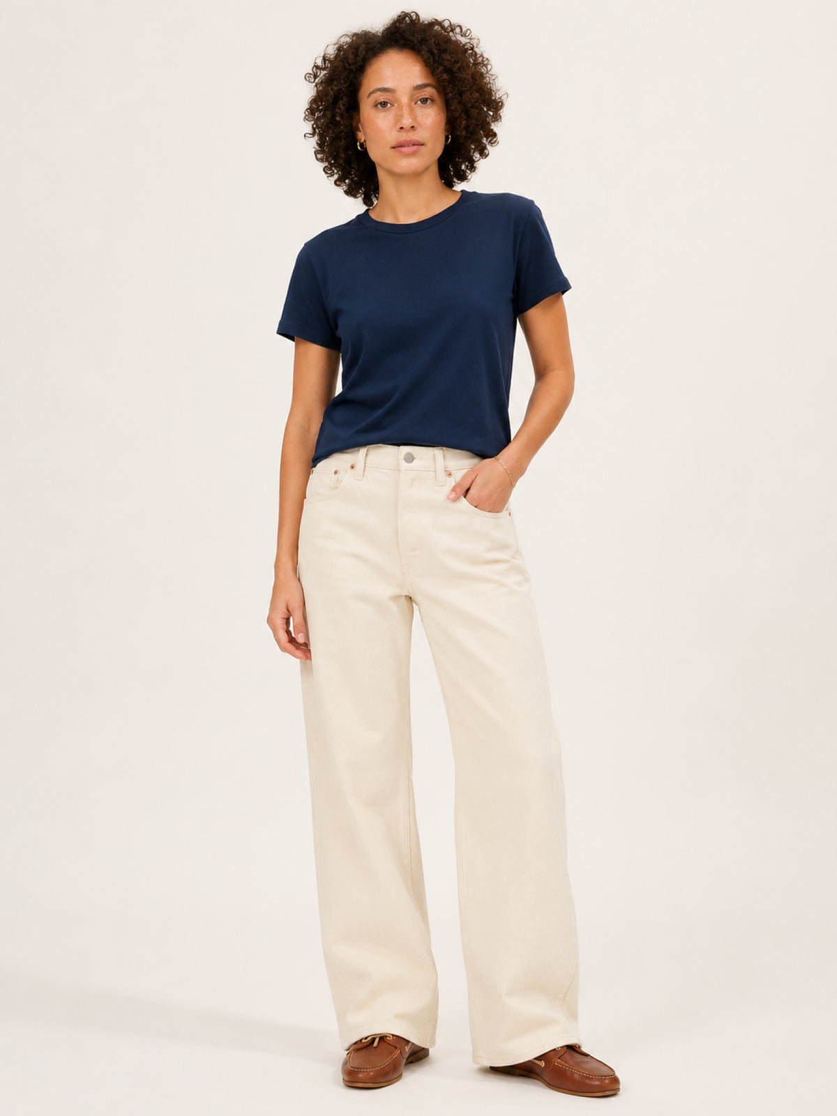 A woman modeling a navy blue short-sleeve crewneck t-shirt
