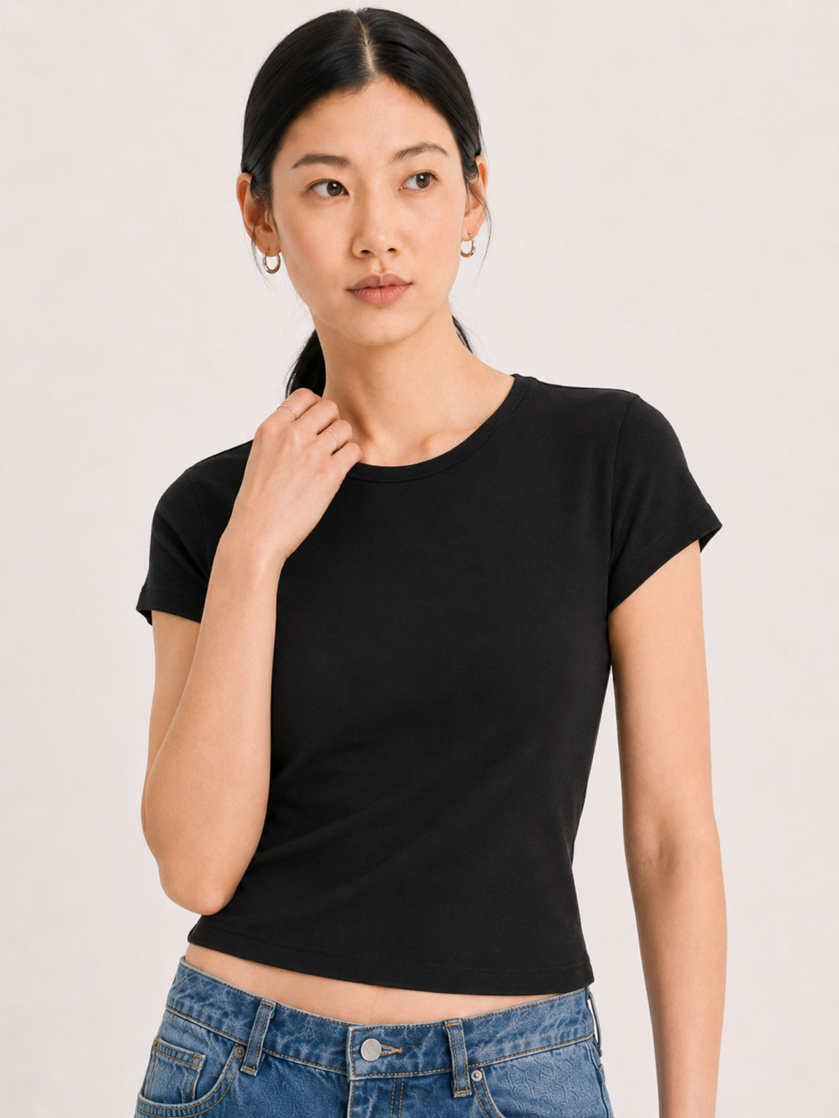 a fitted black short-sleeve crop top